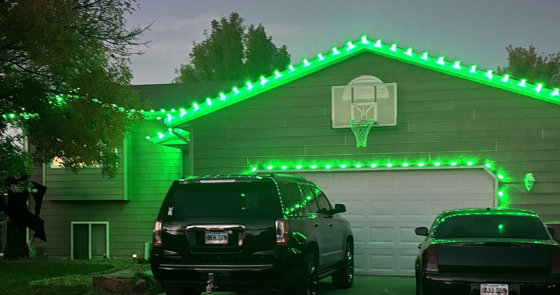 Home decorated with professionally installed Christmas lights at night